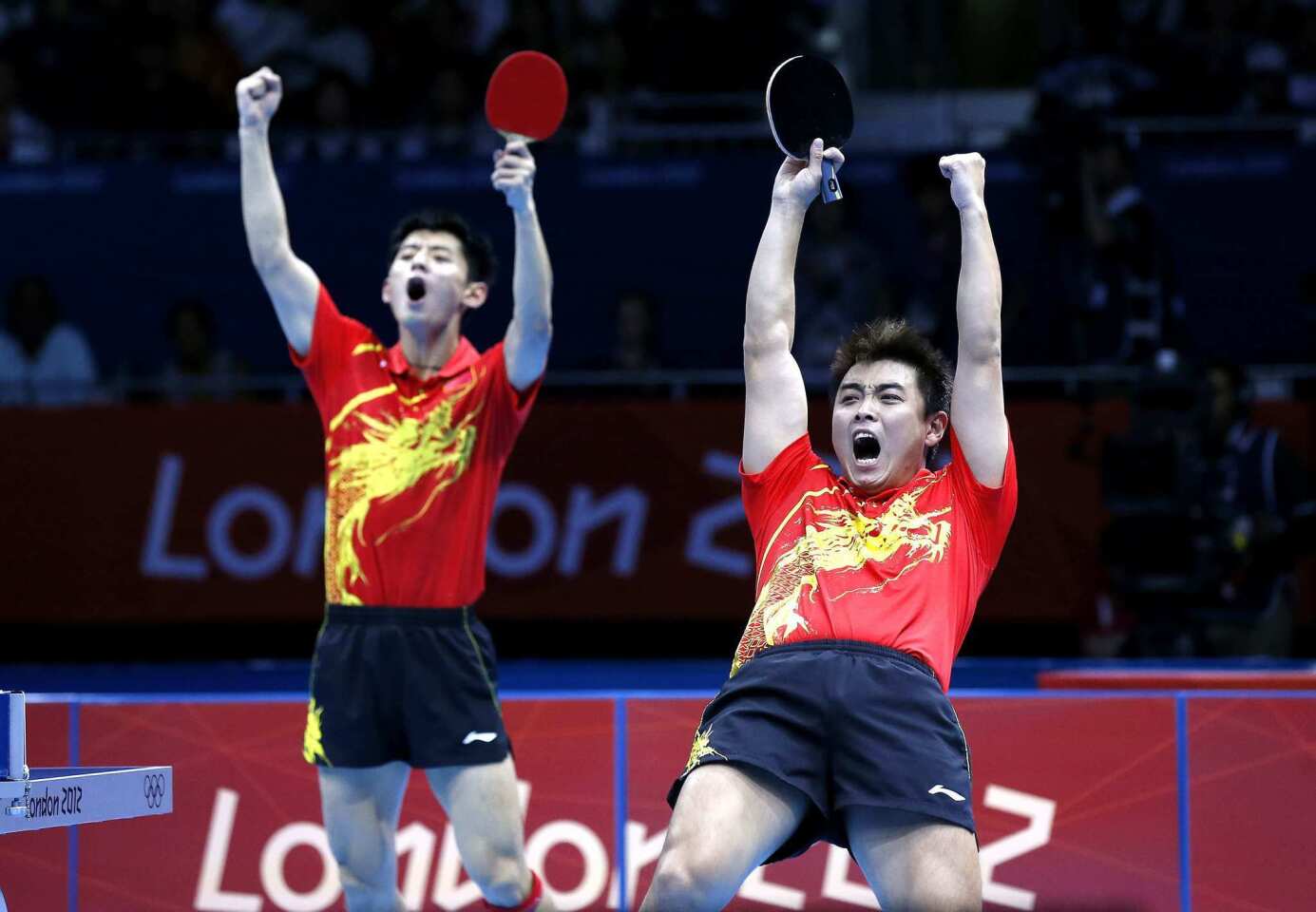 China's Wang Hao, right, and Zhang Jike celebrate their victory in the men's table tennis team gold medal final.