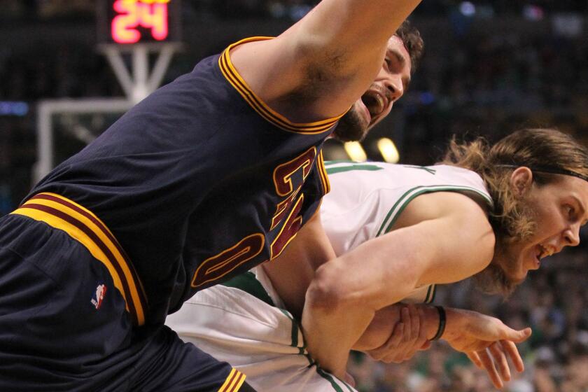 Cleveland Cavaliers forward Kevin Love, left, and Boston Celtics center Kelly Olynyk tangle while chasing after a loose ball during the first quarter of the Cavaliers' 101-93 win in Game 4 of the Eastern Conference quarterfinals on April 26.