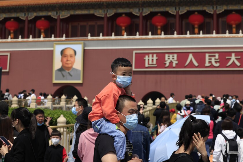 Man with child on his shoulders in Beijing's Tiananmen Square