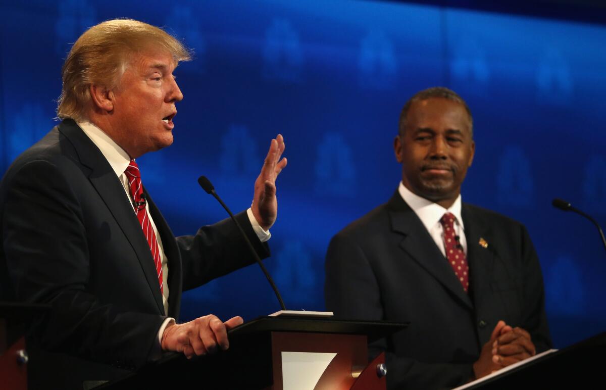 Presidential candidates Donald Trump and Ben Carson take part in the CNBC Republican Presidential Debate at the University of Colorado.