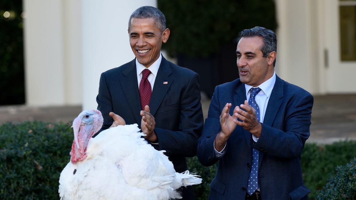 President Barack Obama, with National Turkey Federation Chairman Jihad Douglas, pardons the National Thanksgiving Turkey "Abe" on Nov. 25, 2015.