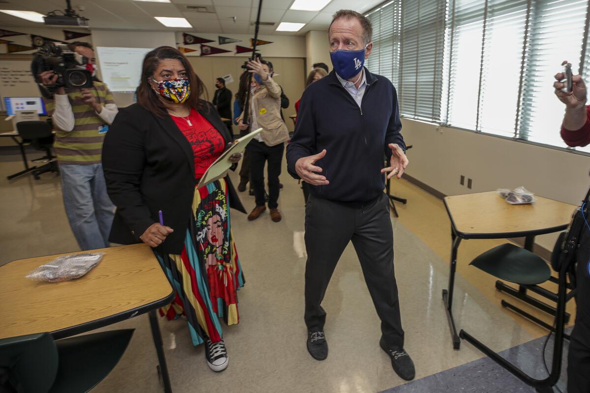 Teachers union President Cecily Myart-Cruz and LAUSD Supt. Austin Beutner walk in a classroom
