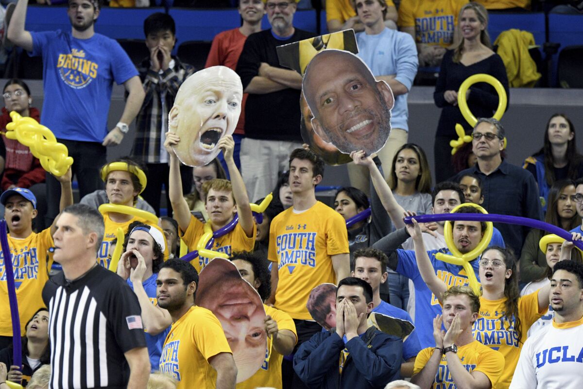 UCLA fans wave cardboard cutouts during a game at Pauley Pavilion in January 2020.