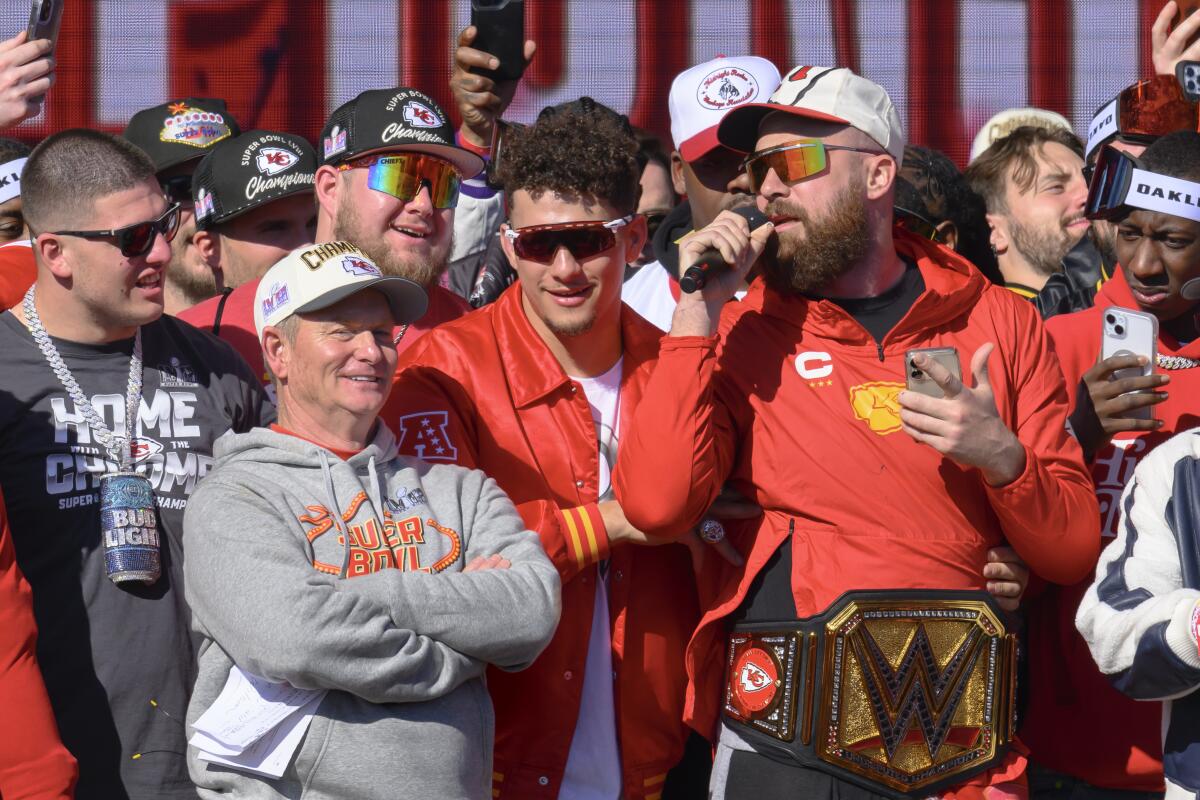 Chiefs tight end Travis Kelce serenades the crowd as Patrick Mahomes and teammates look on at Kansas City's Super Bowl rally