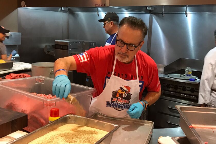 Angels manager Joe Maddon serves food at a dinner for homeless people he calls "Thanksmas" at Metropolitan Ministries in Tampa, Fla., last month. (Rick Vaughn/Respect 90M)
