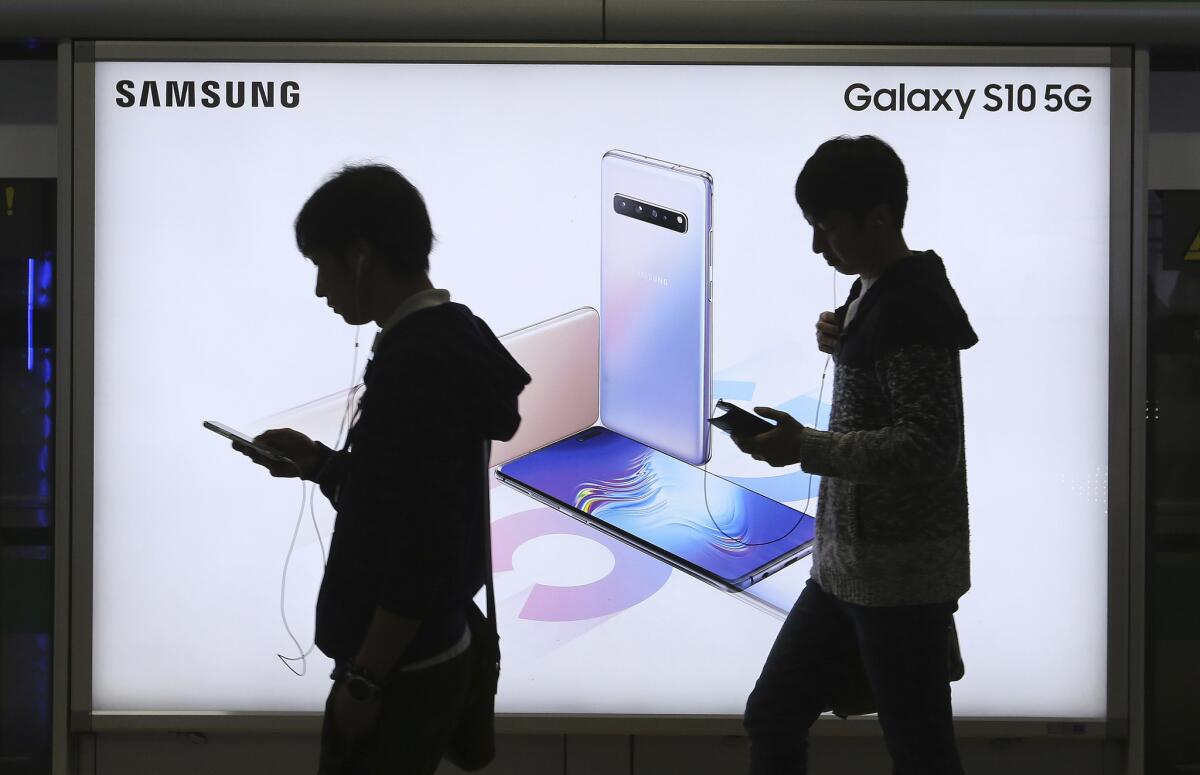 People pass by an advertisement of Samsung Electronics' Galaxy S10 5G smartphone at a subway station in Seoul last year. 