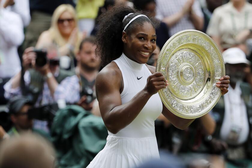 Serena Williams holds her trophy after winning the Wimbledon women's singles final against Angelique Kerber on July 9, 2016.