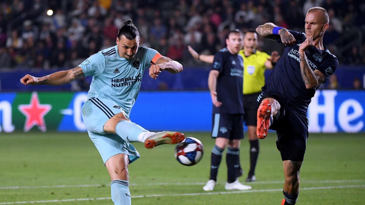 Zlatan Ibrahimovic (left) of the Galaxy attempts a shot in front of Aljaz Struna (right) of Houston Dynamo during a 2-1 Galaxy win at Dignity Health Sports Park.