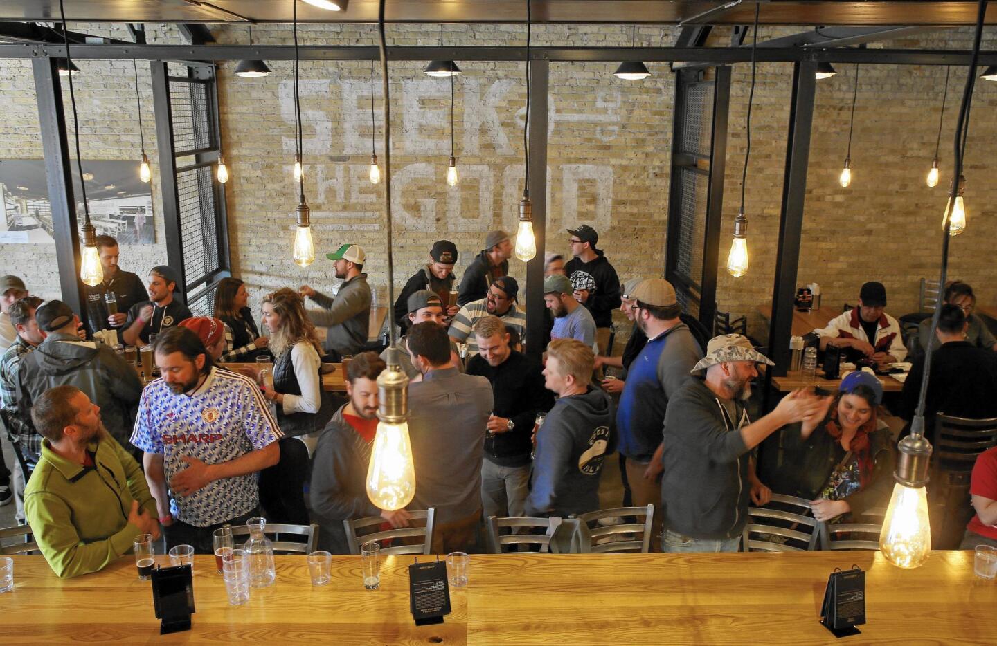 Patrons drink in the taproom at Good City Brewing, which opened last year.