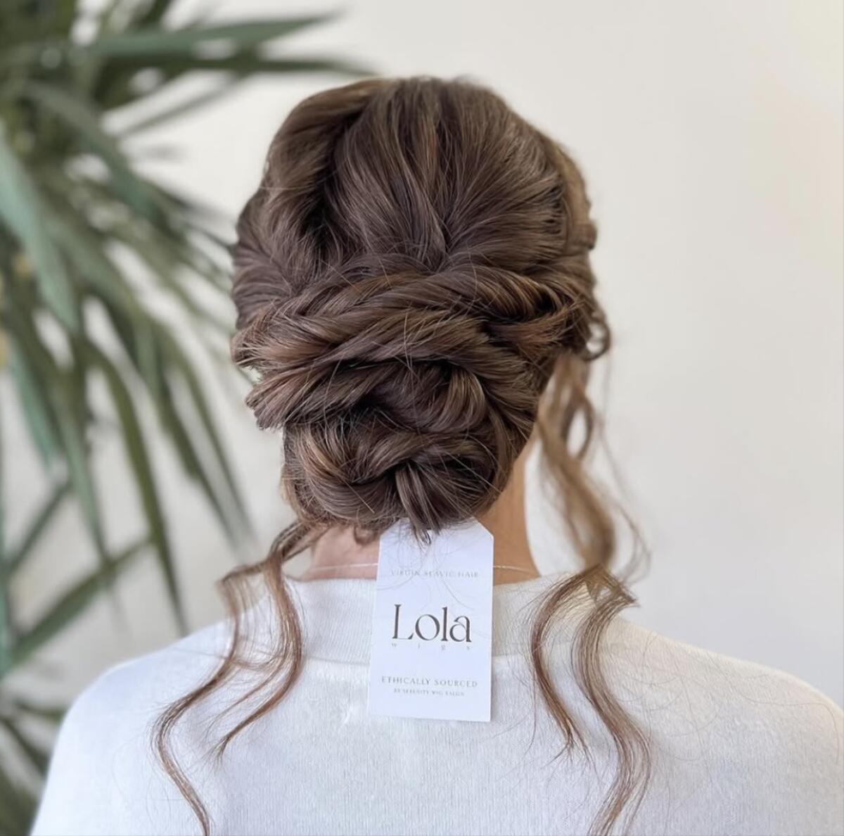 A bridal wig styled in an updo.