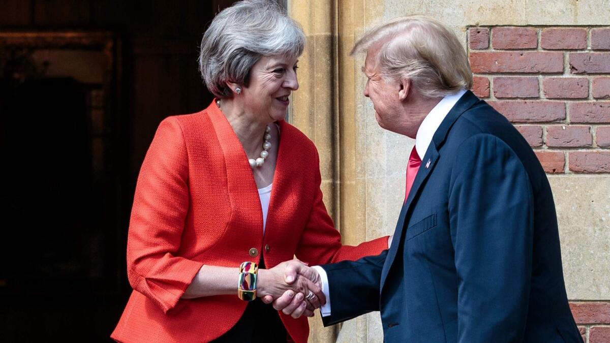 British Prime Minister Theresa May shakes hands with President Trump before their meeting at the prime minister's country residence on Friday.