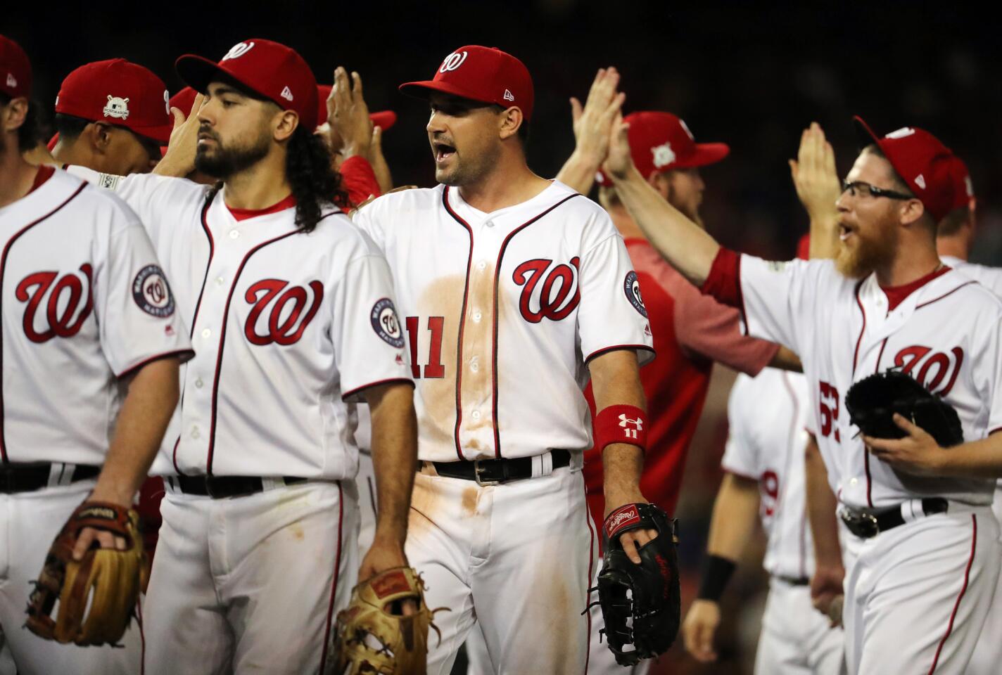 Nationals first baseman Ryan Zimmerman (11) celebrates the win with his teammates.