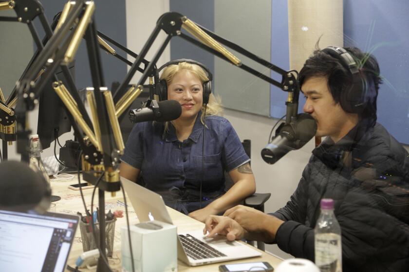 LOS ANGELES, CA -- DECEMBER 11, 2018: Guest Kulap Vilaysack, left, joins an episode of "Yo, Is This Racist?" with host Andrew Ti at comedy podcasting network "Earwolf." The company has expanded to include big-name talents including Conan O'Brien. (Myung J. Chun / Los Angeles Times)