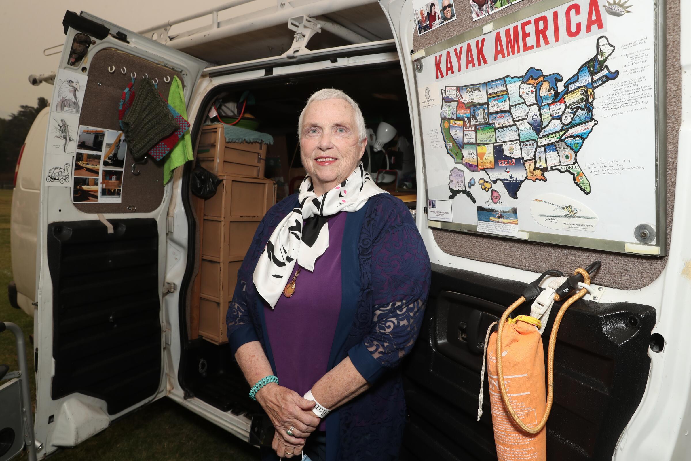 Charlene Swankie stands at the back of her van at the “Nomadland” drive-in premiere at Pasadena's Rose Bowl.