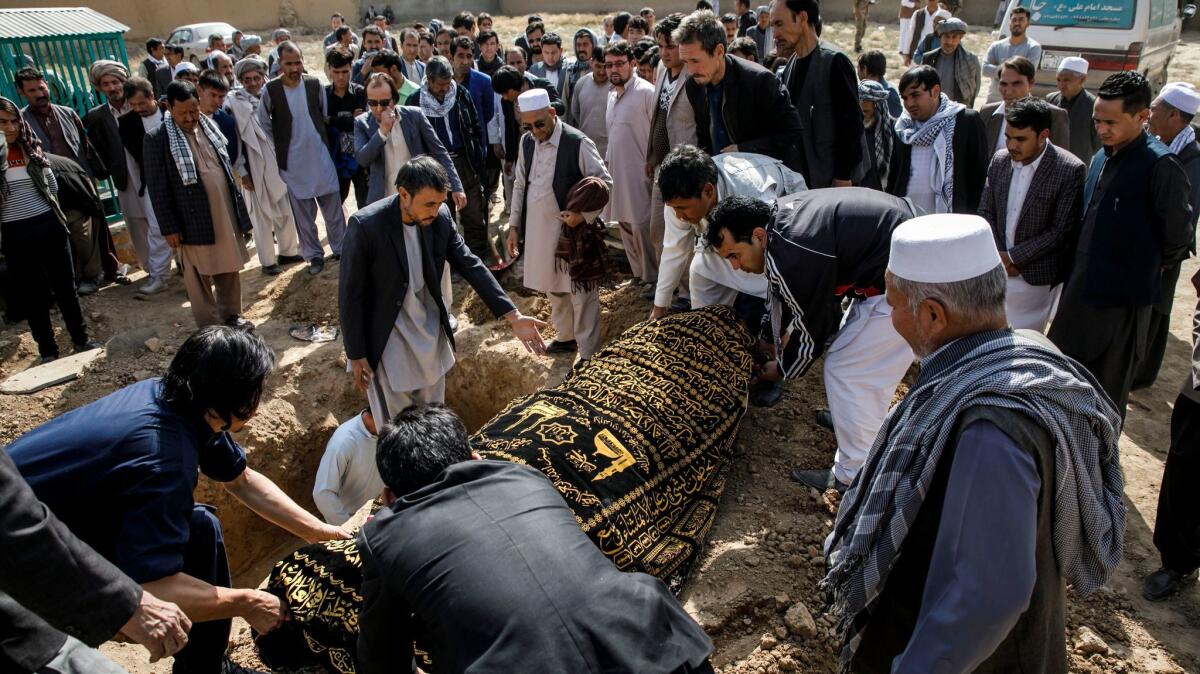 Mourners bury Karbalai Mohammad Anwar Noori, 83, who was killed after a suicide bomber blew himself up inside the packed Imam Zaman mosque on Friday evening.