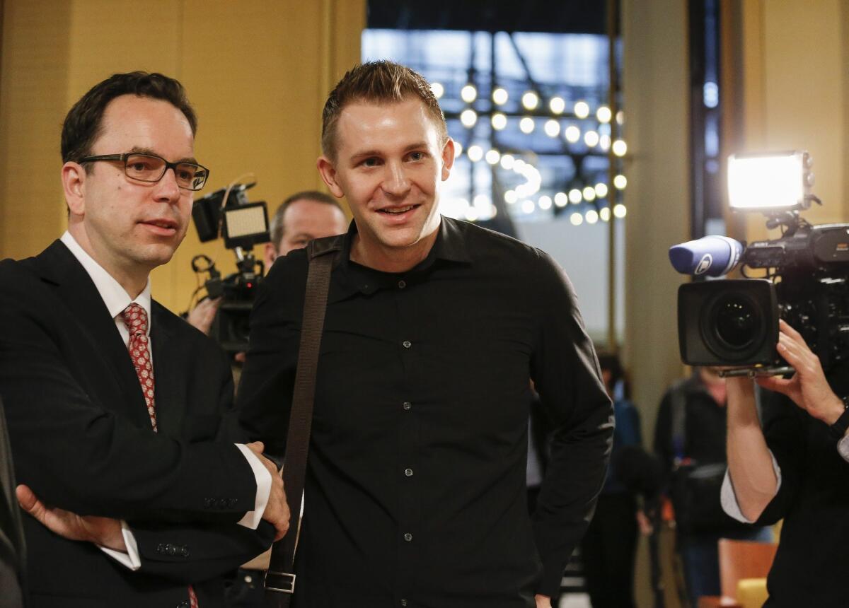 Austrian Max Schrems (center), who filed a data privacy infringement lawsuit against Facebook, stands with his lawyer after the verdict of the European Court of Justice was announced on Oct. 6 in Luxembourg.