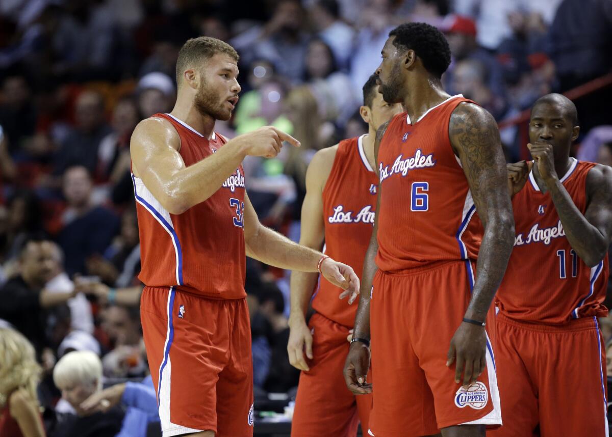 Clippers big men Blake Griffin and DeAndre Jordan talk during the first half of a game against the Heat on Nov. 20. The Clippers beat Miami, 110-93.