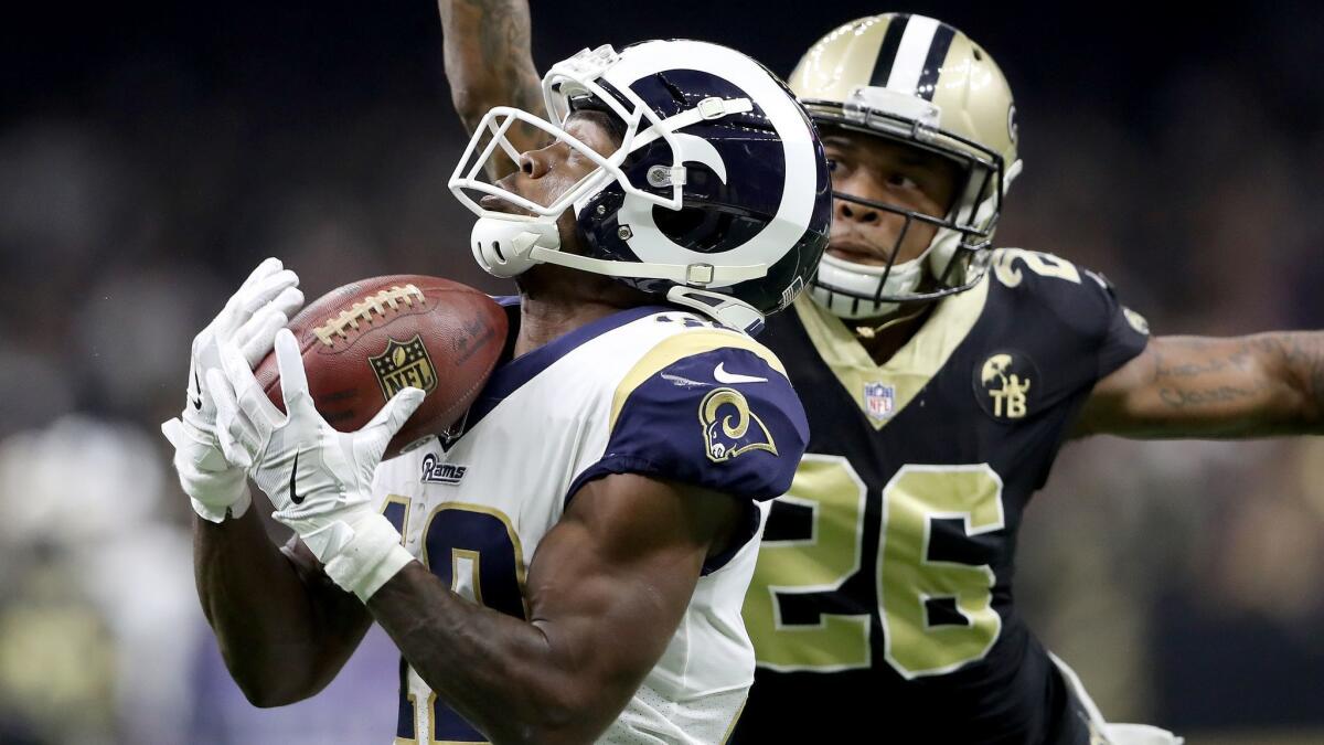 Rams wide receiver Brandin Cooks, left, hauls in a pass ahead of Saints cornerback P.J. Williams during the second quarter of Sunday's game.