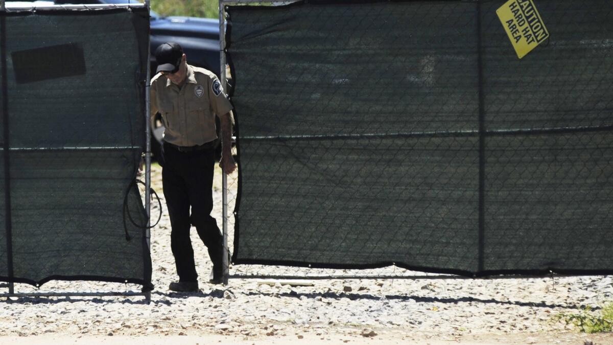 A security guard closes a gate Thursday at the construction site of a new clinic that is being built by Planned Parenthood in Birmingham, Ala.