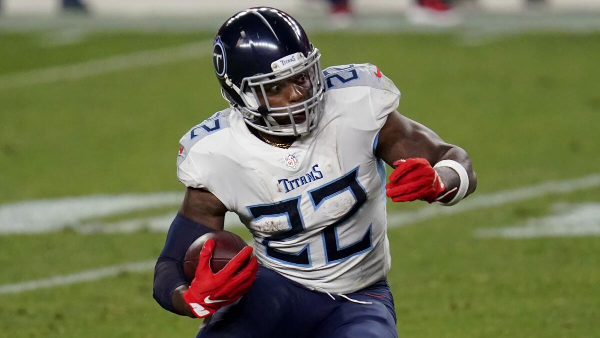 Tennessee Titans running back Derrick Henry carries the ball against the Denver Broncos.