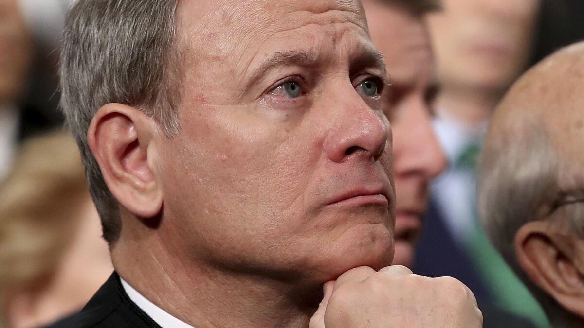 Supreme Court Chief Justice John G. Roberts Jr. listens as President Trump delivers his first State of the Union address to a joint session of Congress in 2018.