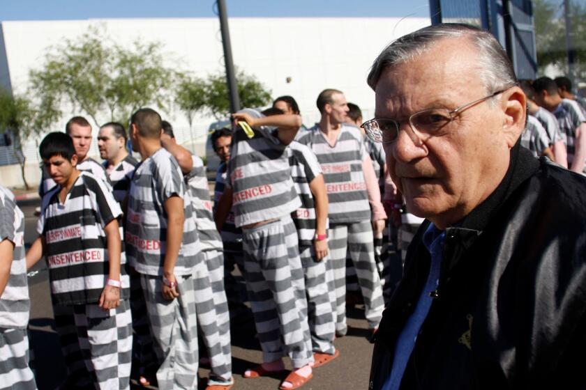 FILE: Arizona Sheriff Joe Arpaio has been found guilty of criminal contempt for ignoring a 2011 court order to stop racially profiling Latinos during patrols. PHOENIX, AZ - APRIL 17: Inmates walk as they are moved after being ordered by Maricopa County Sheriff Officer Joe Arpaio (R), looking on, to be placed into new housing to open up new beds for maximum security inmates on April 17, 2009 in Phoenix, Arizona. Arpaio has been facing criticism from Hispanic activists and lawmakers, alleging that Arpaio's crackdown methods on illegal immigrants involve racial profiling. (Photo by Joshua Lott/Getty Images) ** OUTS - ELSENT, FPG, CM - OUTS * NM, PH, VA if sourced by CT, LA or MoD **