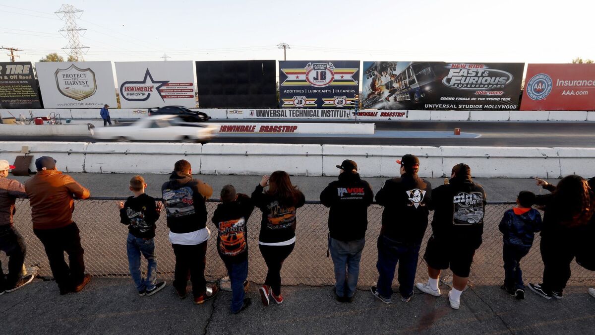 Spectators watch drag races at the Irwindale Speedway in Irwindale.