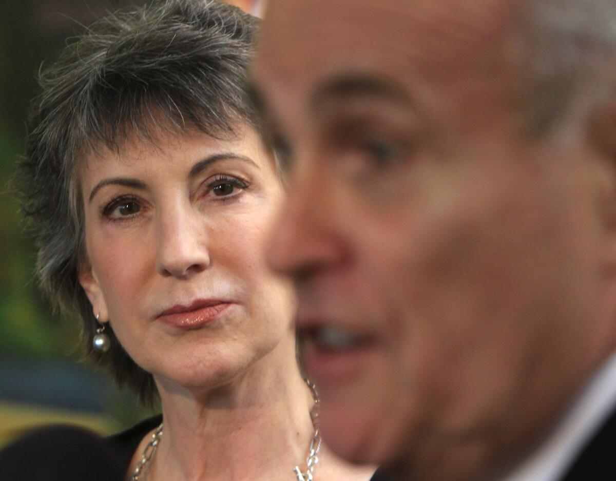 Carly Fiorina looks on as Former New York City Mayor Rudy Giuliani endorses her during a news conference at the Asian Garden Mall in Westminster in October 2010.