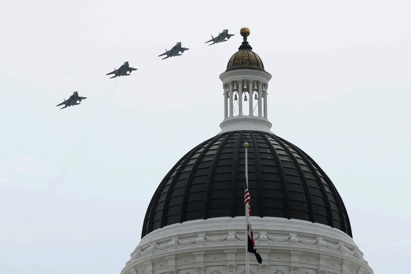 Four fighter jets fly over the dome of California's state Capitol.