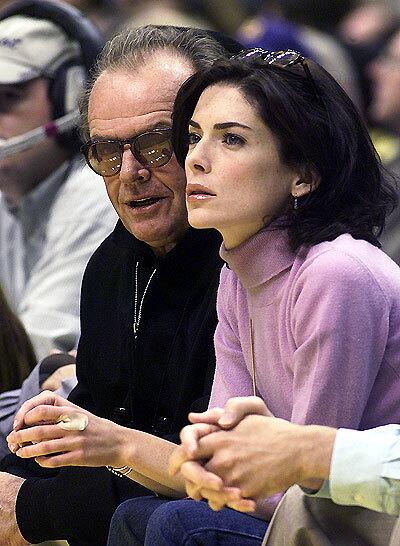 Jack Nicholson and his former girlfriend, actress Lara Flynn Boyle, watch the Lakers play the Vancouver Grizzlies at Staples Center in 1999.