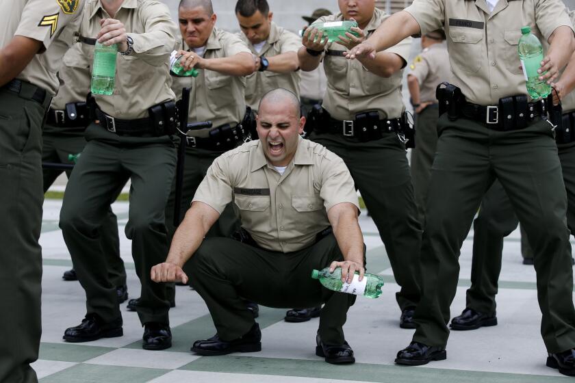 Los Angeles County Sheriff's Department recruits grimace in pain on the first day of training, known as "Black Monday."