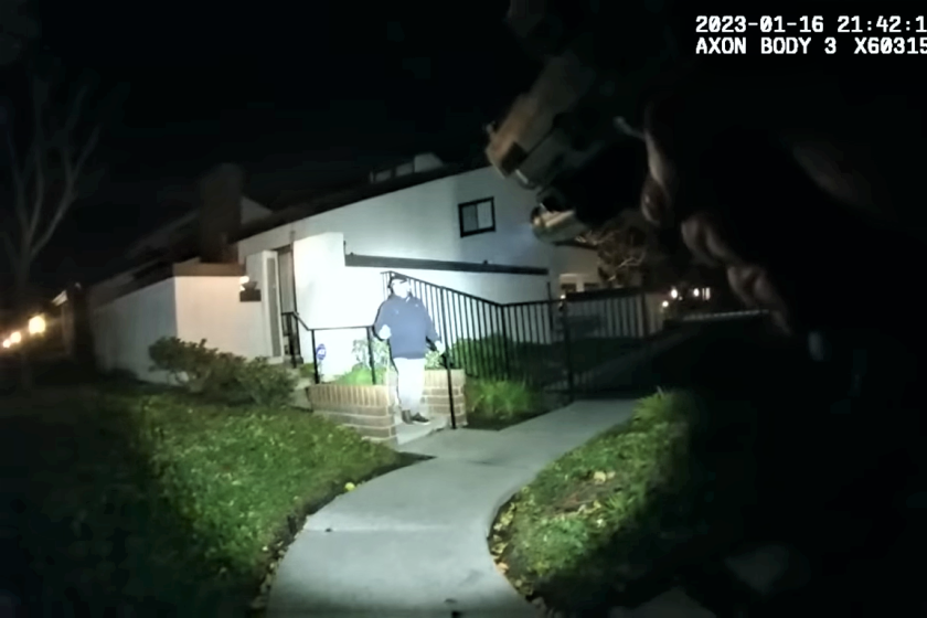 A still taken from officer body camera footage recorded on Jan. 17 shows a Seal Beach police officer with his gun drawn.