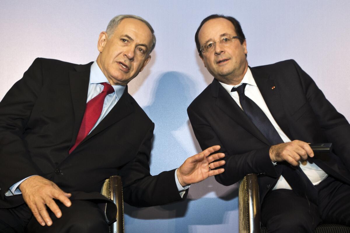 Israeli Prime Minister Benjamin Netanyahu, left, confers with French President Francois Hollande during a visit to a French-Israeli technology innovation summit at a hotel in Tel Aviv.