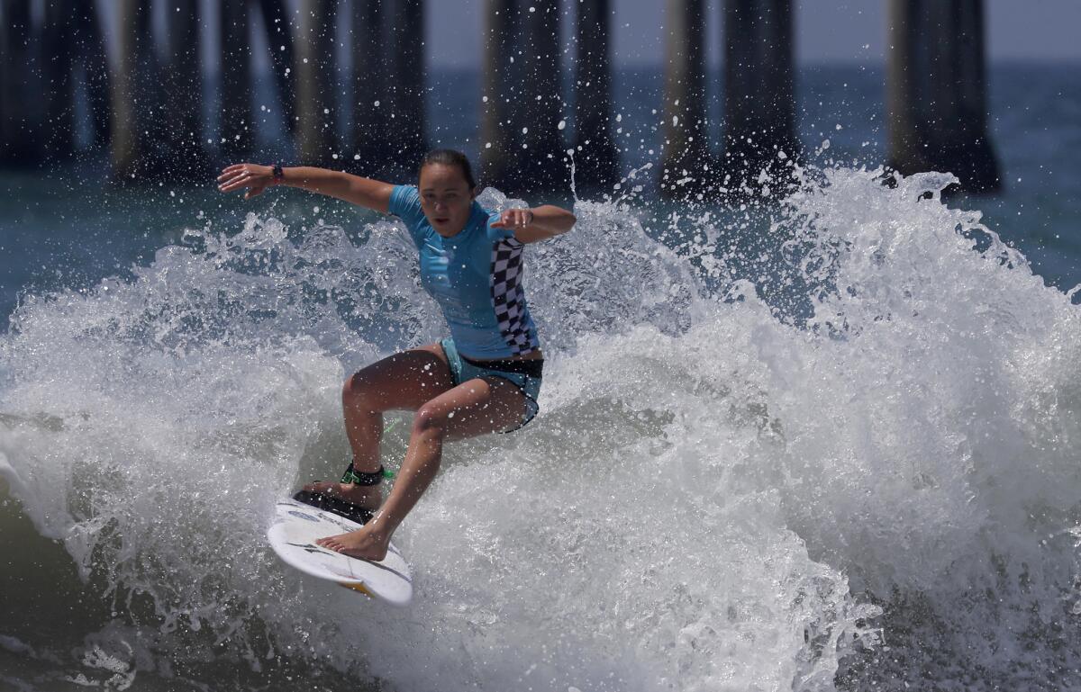 HUNTINGTON BEACH, CALIF. - AUG. 5, 2018. Carissa Moore competes against Stephanie Gilmore in the women's semifinals of the 2018 Vans U.S, Open of Surfing on Sunday, Aug. 5, 2018, in Huntington Beach. (Luis Sinco/Los Angeles Times)