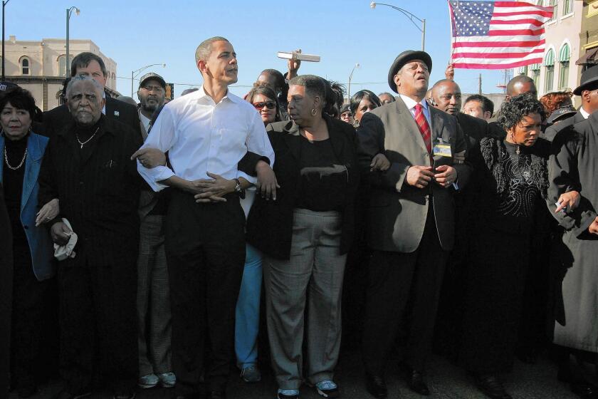As a candidate in 2007, Sen. Barack Obama joins a march to the Edmund Pettus Bridge in Selma, Ala. He will return there as president this weekend to mark the 50th anniversary of the voting rights march.