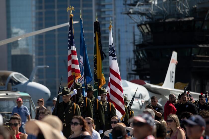 Members of the U.S. Border Patrol Honor Guard march toward the bow of the USS Midway Museum to present the colors during the 21st anniversary memorial of 9/11 flight deck on Sunday, Sept. 11, 2022.