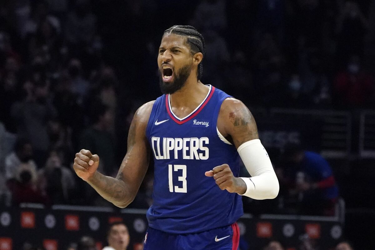 Los Angeles Clippers guard Paul George (13) reacts after a late basket by guard Reggie Jackson during the second half of an NBA basketball game against the Oklahoma City Thunder Monday, Nov. 1, 2021, in Los Angeles. (AP Photo/Marcio Jose Sanchez)