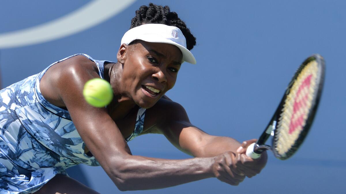 Venus Williams hits a return during her victory over Kimiko Date-Krumm in the first round of the U.S. Open on Monday.