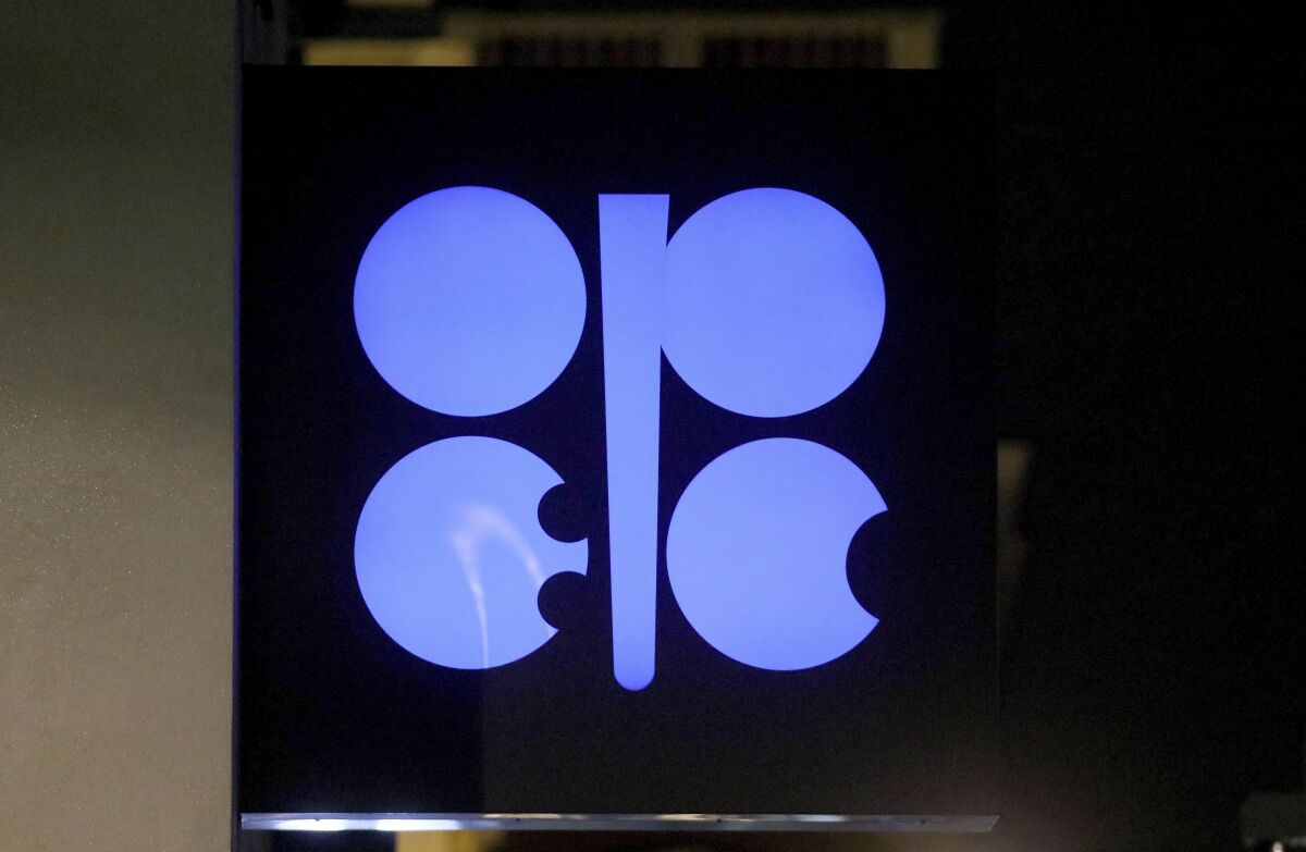 FILE - In this Dec. 19, 2019 file photo, the advertising label of the Organization of the Petroleum Exporting Countries, OPEC, shines at their headquarters in Vienna, Austria. OPEC and allied countries including Russia agreed Thursday, Dec. 3, 2020 to increase oil production by 500,000 barrels a day from January and said they would meet monthly to decide further output levels, gingerly adding more crude to a global economy still suffering from the COVID-19 pandemic. (AP Photo/Ronald Zak, File)