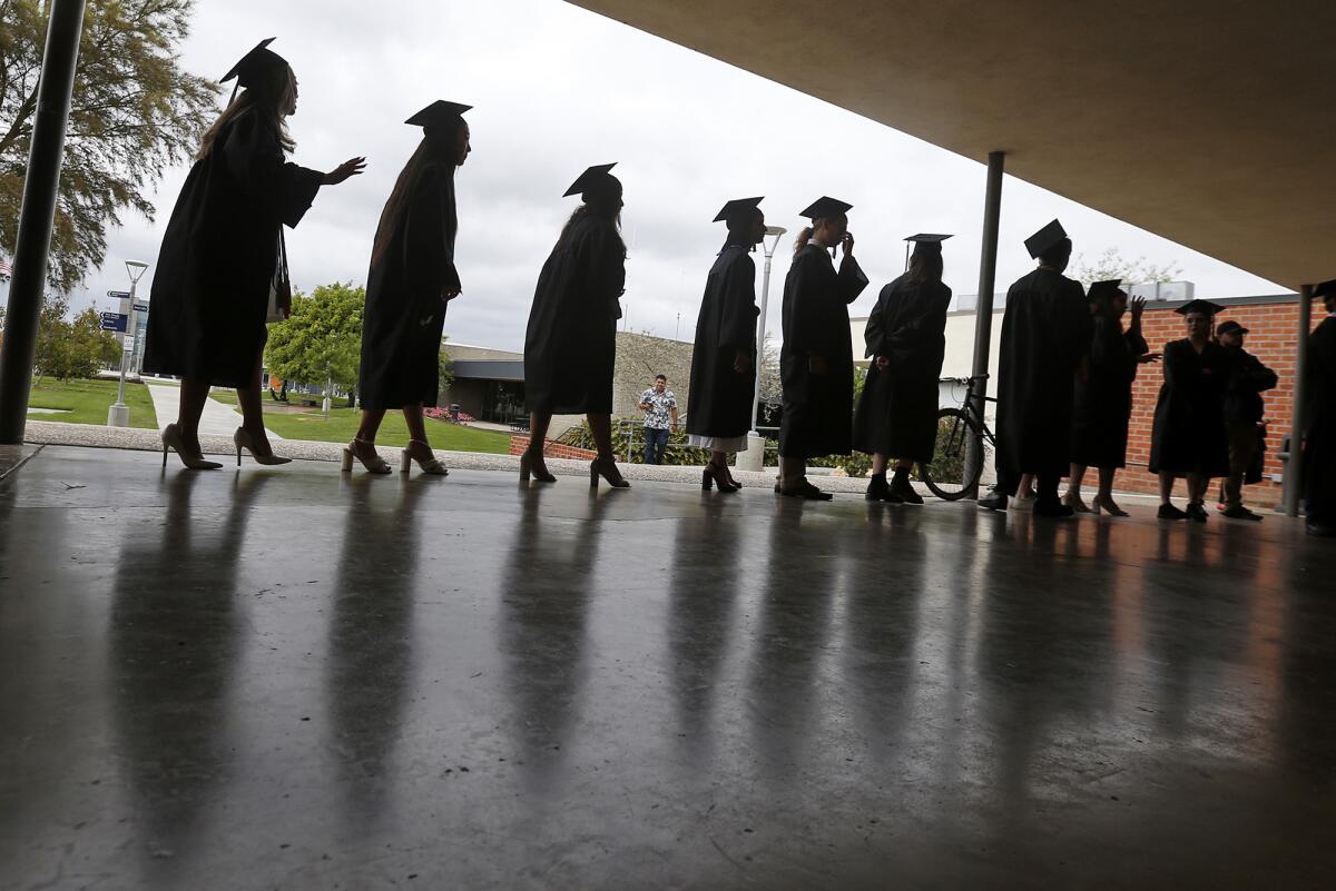 Graduates proceed to the 2023 Early College High School graduation ceremony at the Robert Moore Theater.