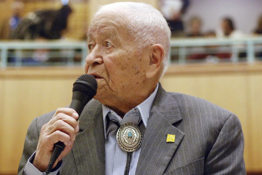 FILE - In this Feb. 2, 2018, fle photo Democratic New Mexico state Sen. John Pinto talks about his career as a lawmaker on American Indian Day in the Legislature on in Santa Fe, N.M. Pinto joined the Senate in 1977 and is 92 years old. He was a Marine who trained as a Navajo code talker during World War II. His singing of the "Potato Song" is an annual Senate ritual. (AP Photo/Morgan Lee, File)
