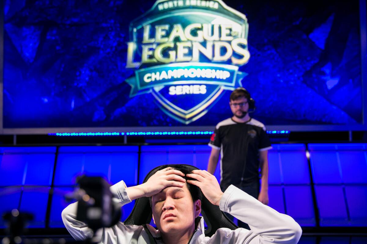 A competitor takes a moment to stretch during a "League of Legends" tournament match at the Riot Games studio in Los Angeles in April.