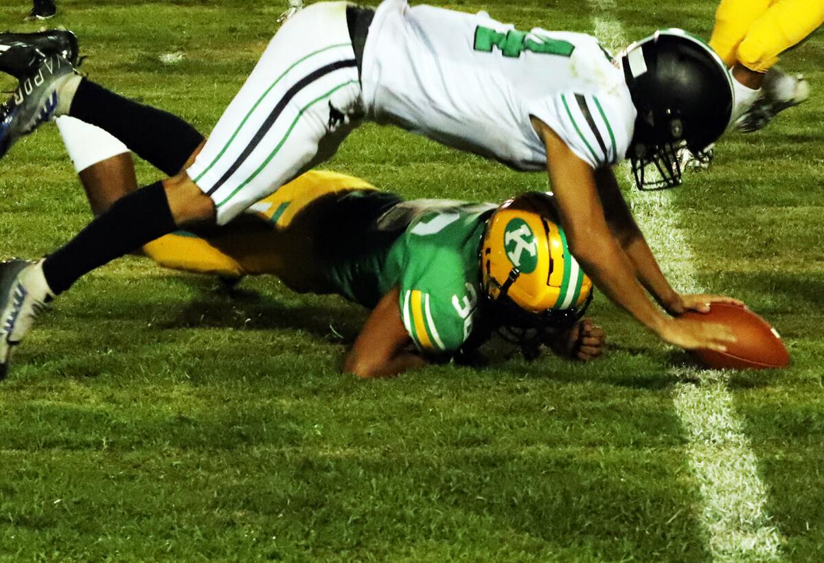 Costa Mesa's Edward Franco (44) attempts to make a fumble recovery against Kennedy in the season opener on Thursday.
