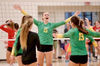 Mira Costa's Rachel Moglia, center, celebrates a three-set win over Mater Dei on Tuesday night in Manhattan Beach.