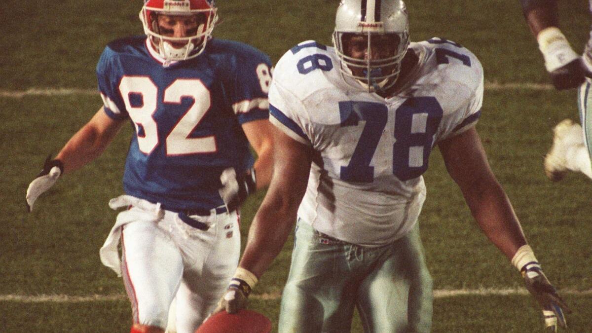 Dallas' Leon Lett, right, celebrates a Super Bowl touchdown too early and is stripped of the ball by Buffalo's Don Beebe.