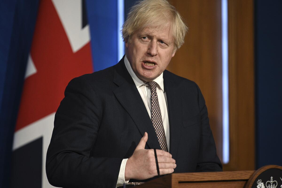 Britain's Prime Minister Boris Johnson speaks during a media briefing on coronavirus in Downing Street, London, Monday, July 5, 2021. Johnson says people in England will no longer be required by law to wear face masks in indoor public spaces and to keep at least 1 meter (3 feet) apart as soon as later this month. Johnson on Monday confirmed plans to reopen society despite rising coronavirus cases. (Daniel Leal-Olivas/Pool Photo via AP)