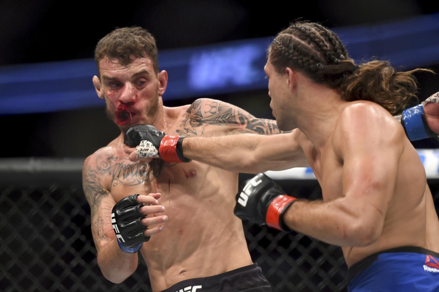Brian Ortega, right, connects with Renato Moicano in the featherweight bout at UFC 214 in Anaheim, Calif., Saturday, July 29, 2017. (Hans Gutknecht /Los Angeles Daily News via AP)