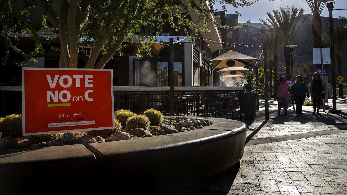 A bright orange "Vote No on C" sign is posted in front of Tommy Bahama's Marlin Bar in Palm Springs.