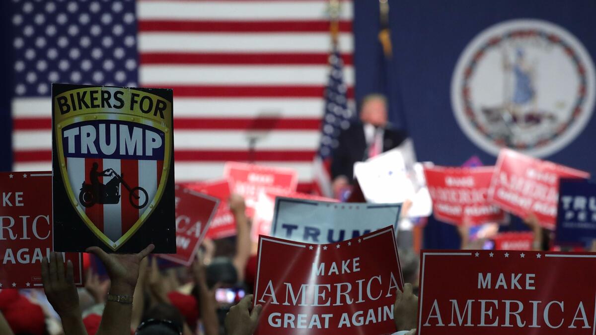 Supporters hold up signs during a campaign rally of Donald Trump at Fredericksburg Expo Center Aug. 20 in Fredericksburg, Va.