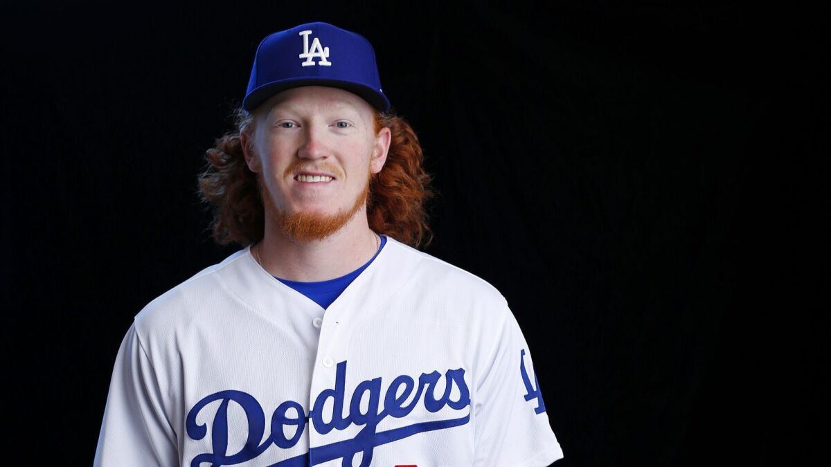 Dustin May is a top pitching prospect and manager Dave Roberts says he might make the major leagues this season.